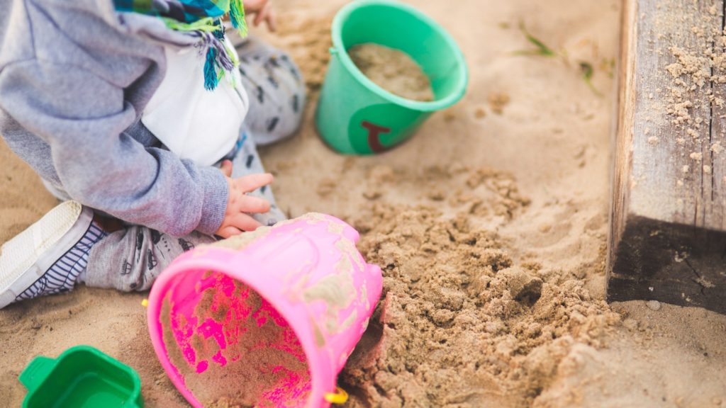 Child playing in sand generic