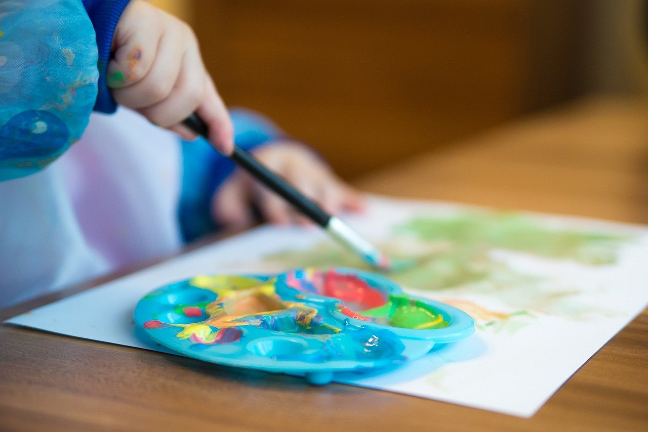 Kid playing with paints generic